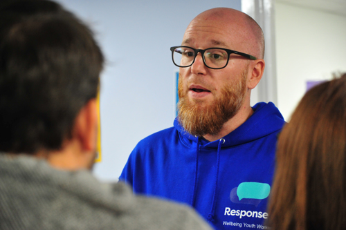 Jamie Douglas, Response's Associate Director of Children, Young People and Families speaks with attendees at the Thatcham Wellbeing Hub launch party.